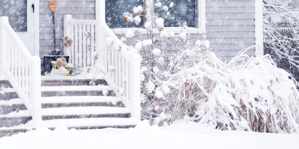 Front door with snow and ice buildup causing sticking in a Pittsburgh home