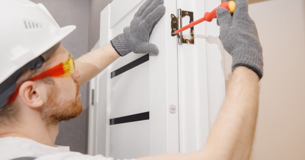 Pittsburgh homeowner evaluating a door for repair or replacement