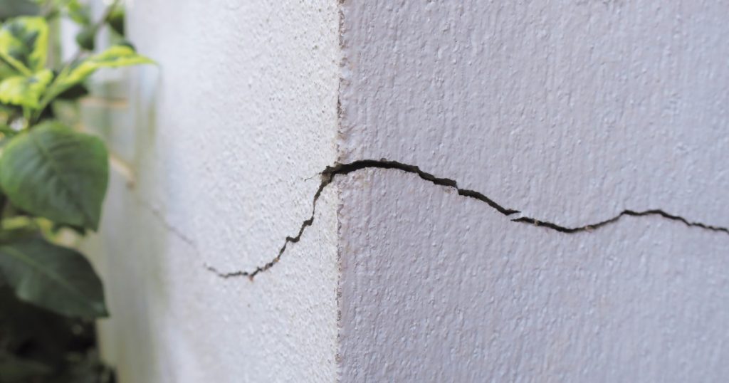 Hairline drywall crack in a Pittsburgh home near a ceiling seam