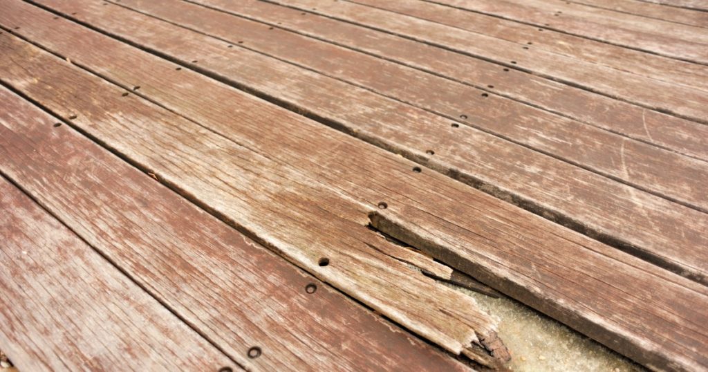 Deck surface showing faded stain after winter weather in Pittsburgh