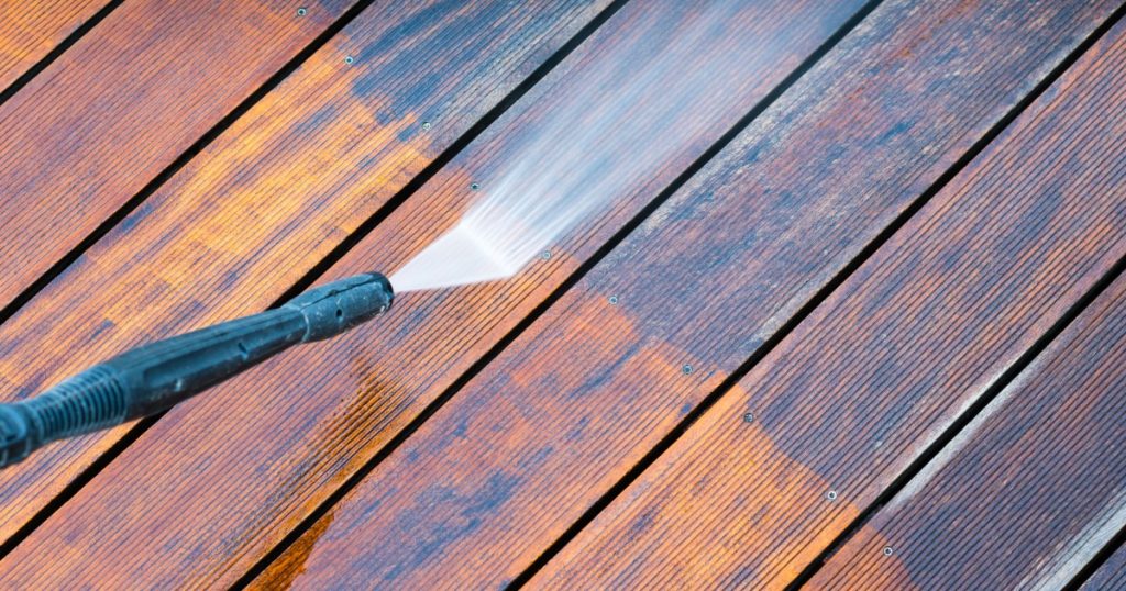 Power washing a wooden deck in Pittsburgh to remove winter buildup