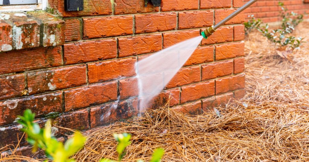 Power washing a residential home exterior in Pittsburgh during spring