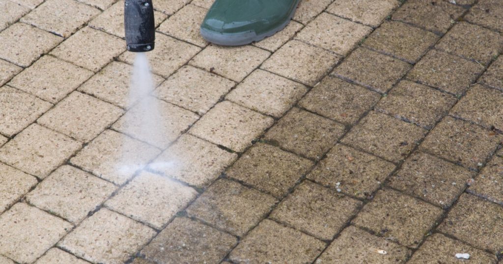 Power washing a driveway in Pittsburgh during spring cleaning