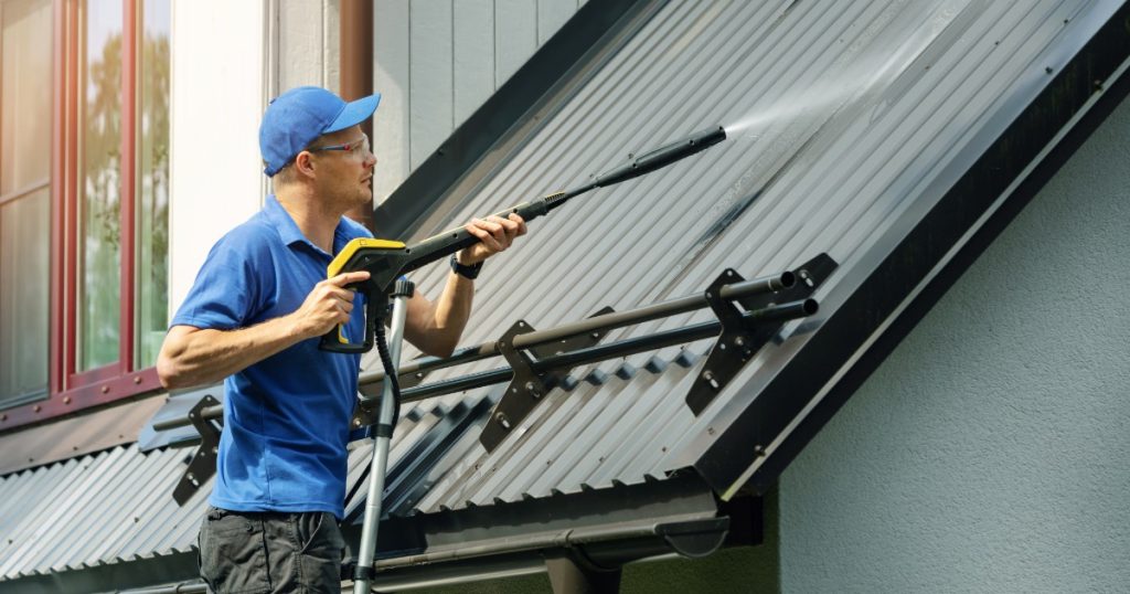 Professional handyman power washing a home exterior in Pittsburgh