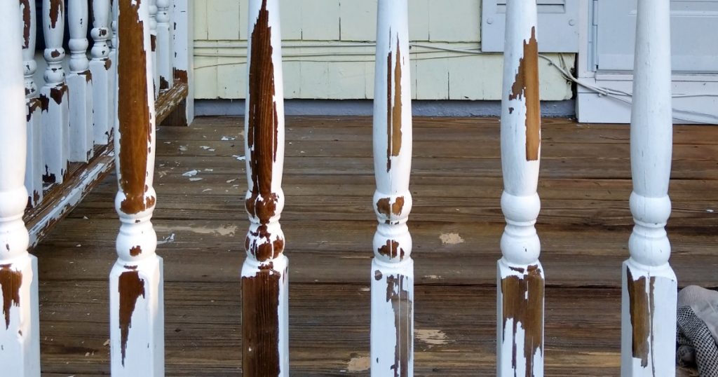 Front porch railing on a Pittsburgh home being checked for movement
