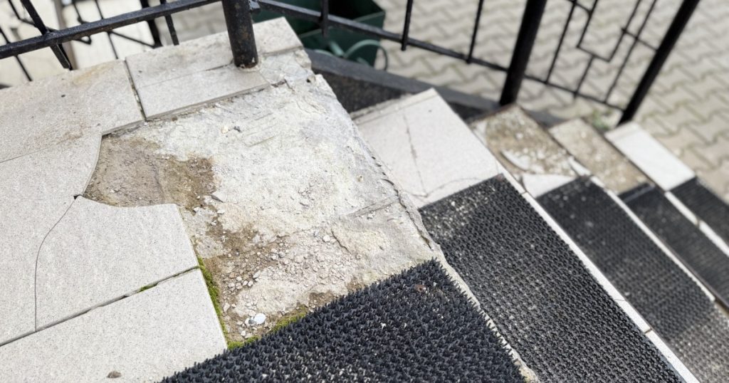 Front steps of a Pittsburgh home showing surface wear and uneven areas