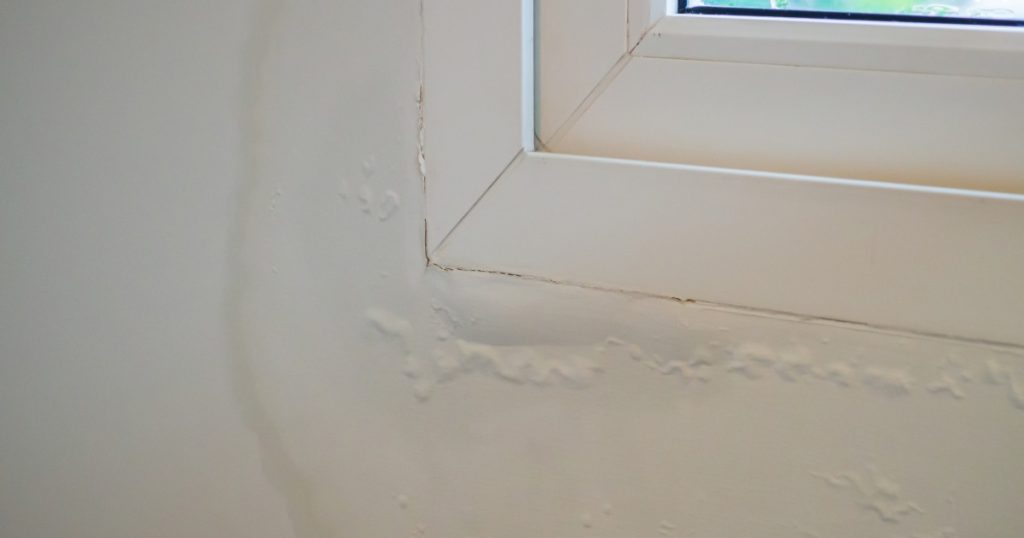 Cracked caulk around a window allowing moisture into the home