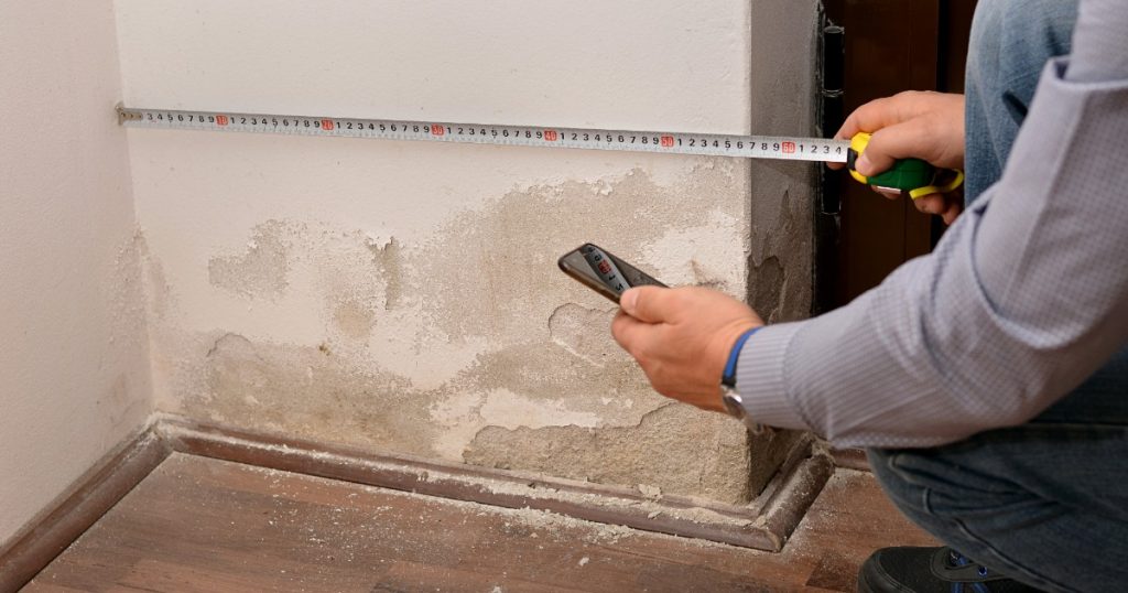 Warped baseboard and separated trim caused by moisture damage