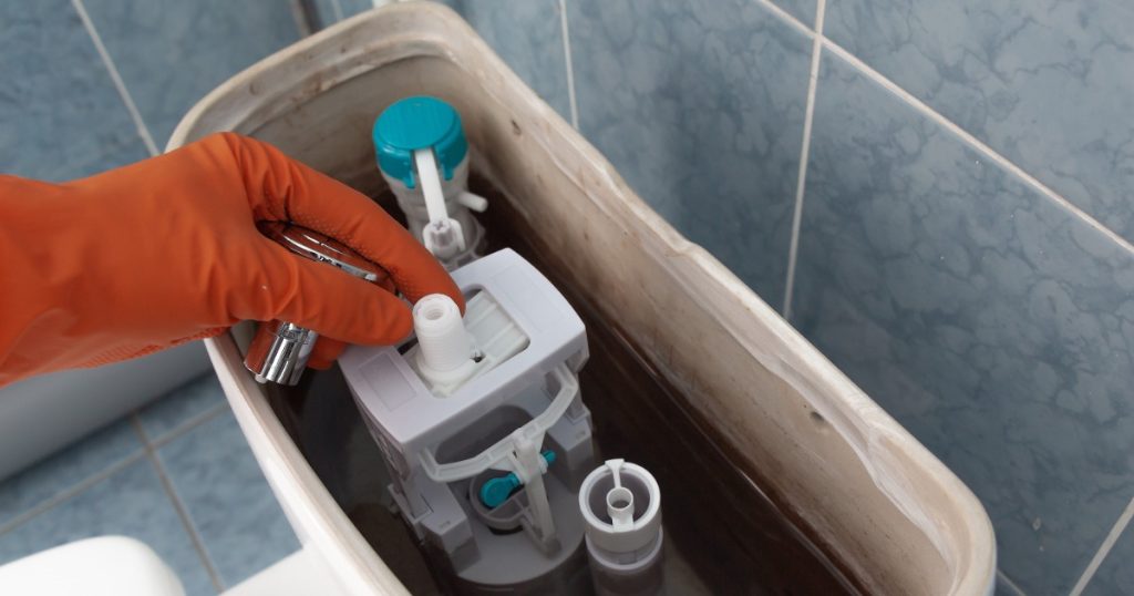 Running toilet with tank components visible — repair or replace decision