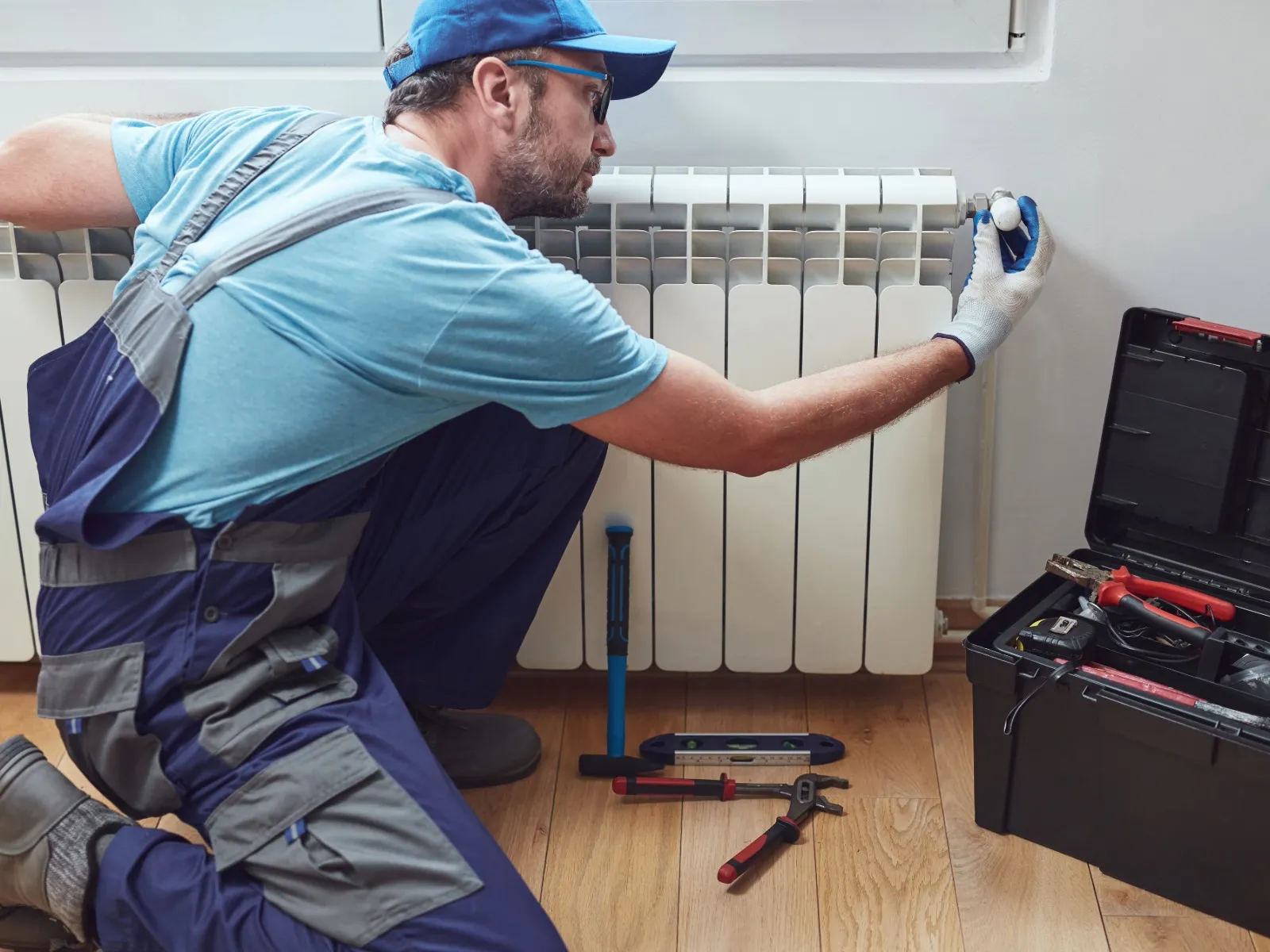 Mt. Lebanon handyman checking radiator in Pittsburgh home