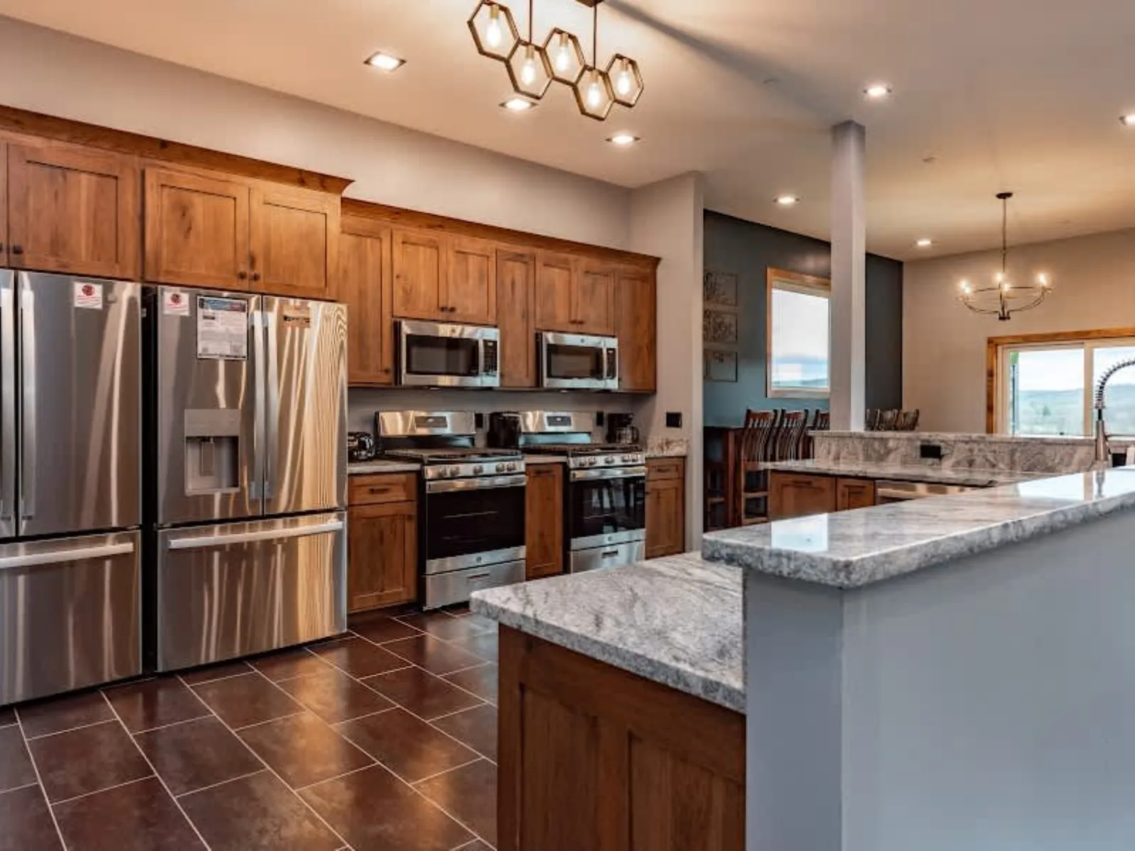 Warm wood kitchen with an island and overhead lighting