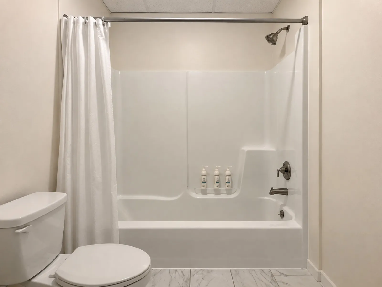 Bright white bathroom with a tub and shower enclosure