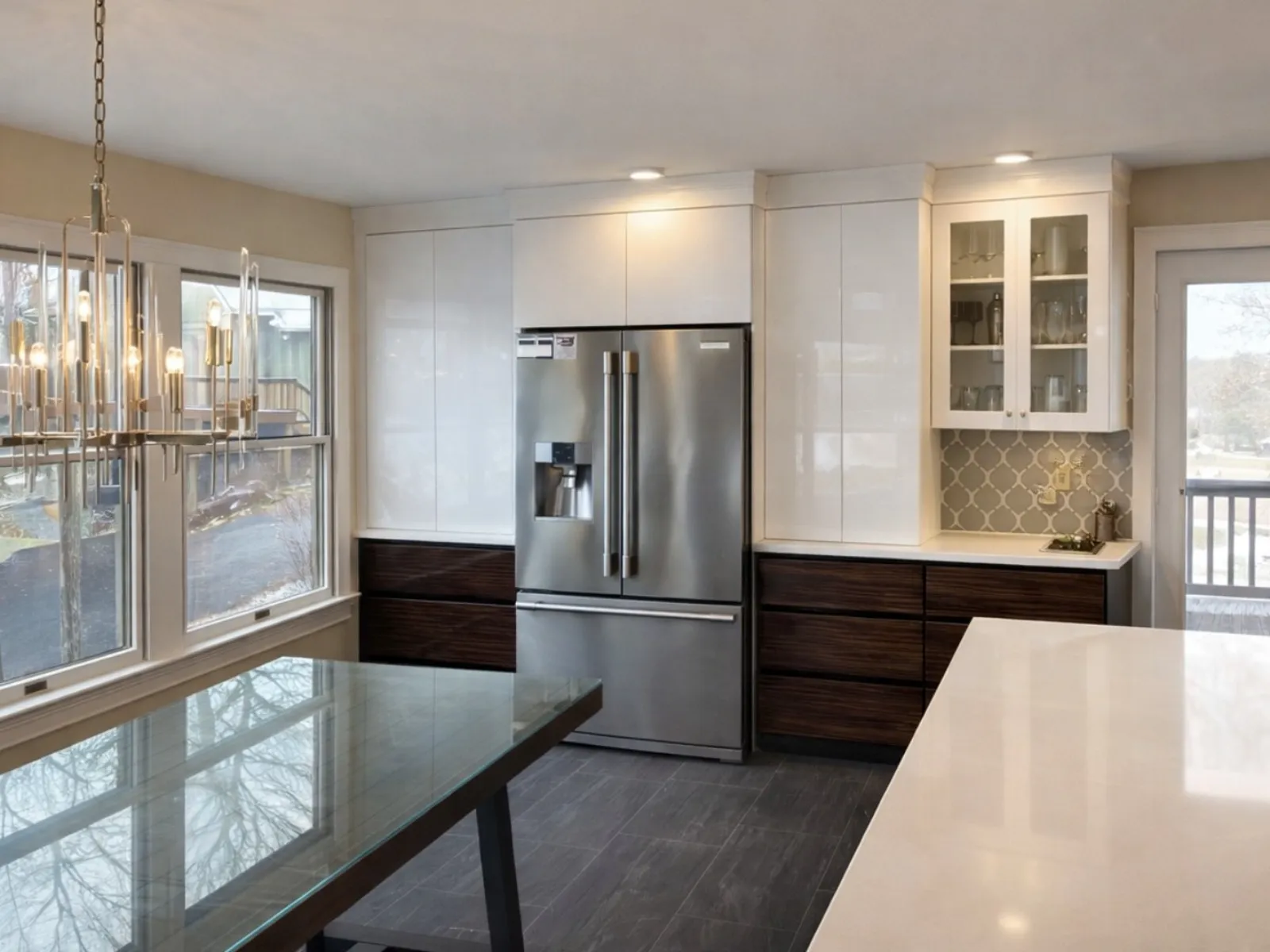 Renovated kitchen with white cabinets and dark countertops