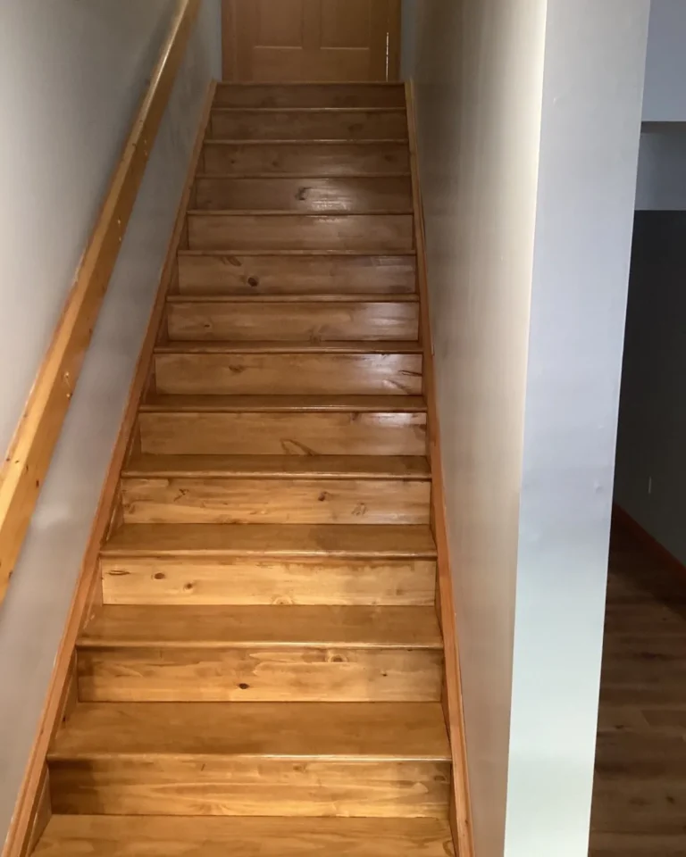 Refinished wooden staircase viewed from the hallway