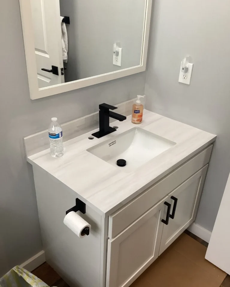 Finished white bathroom vanity with black fixtures