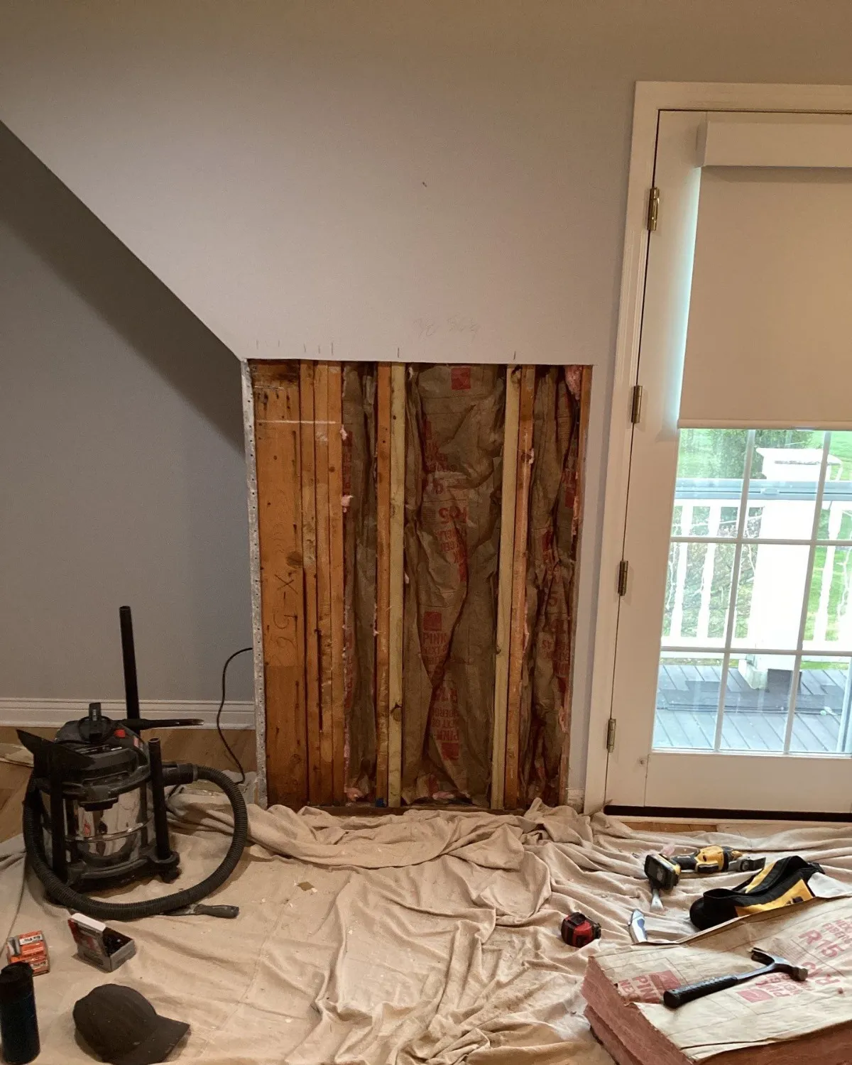 Interior room with exposed framing during repair