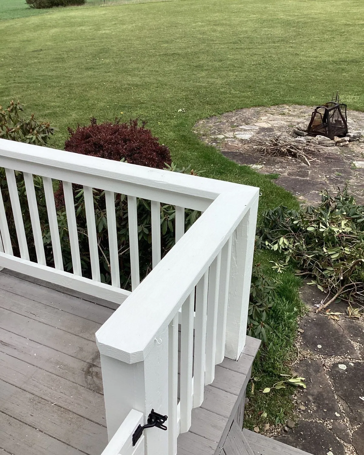 White porch railing with a clean refreshed finish after exterior painting