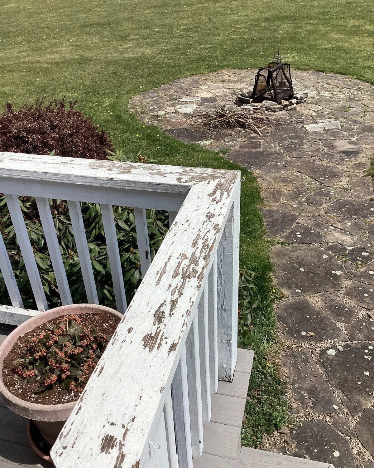 White porch railing with peeling and chipped paint before exterior painting