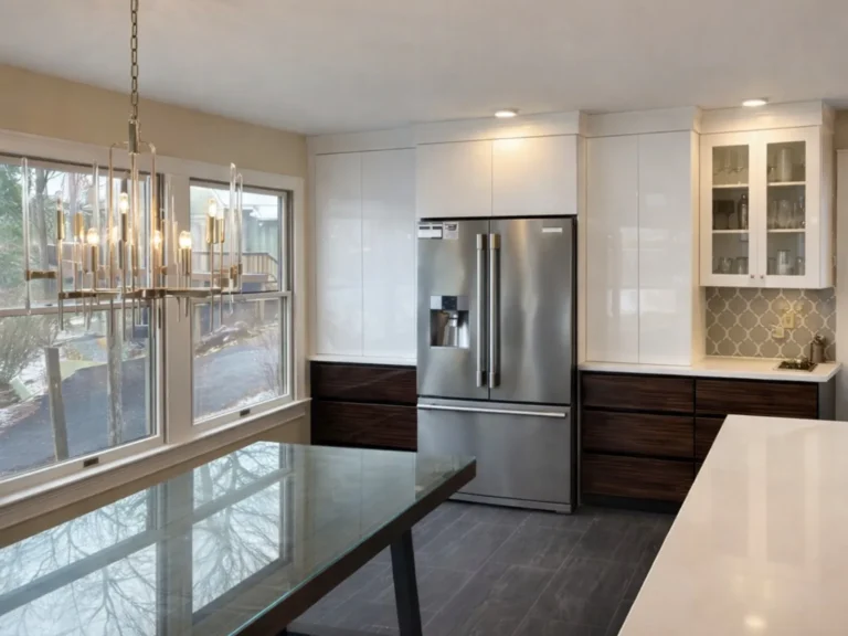 Renovated kitchen with white cabinets and dark countertops