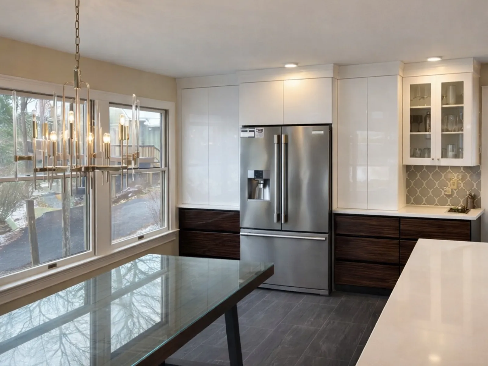 Renovated kitchen with white cabinets and dark countertops