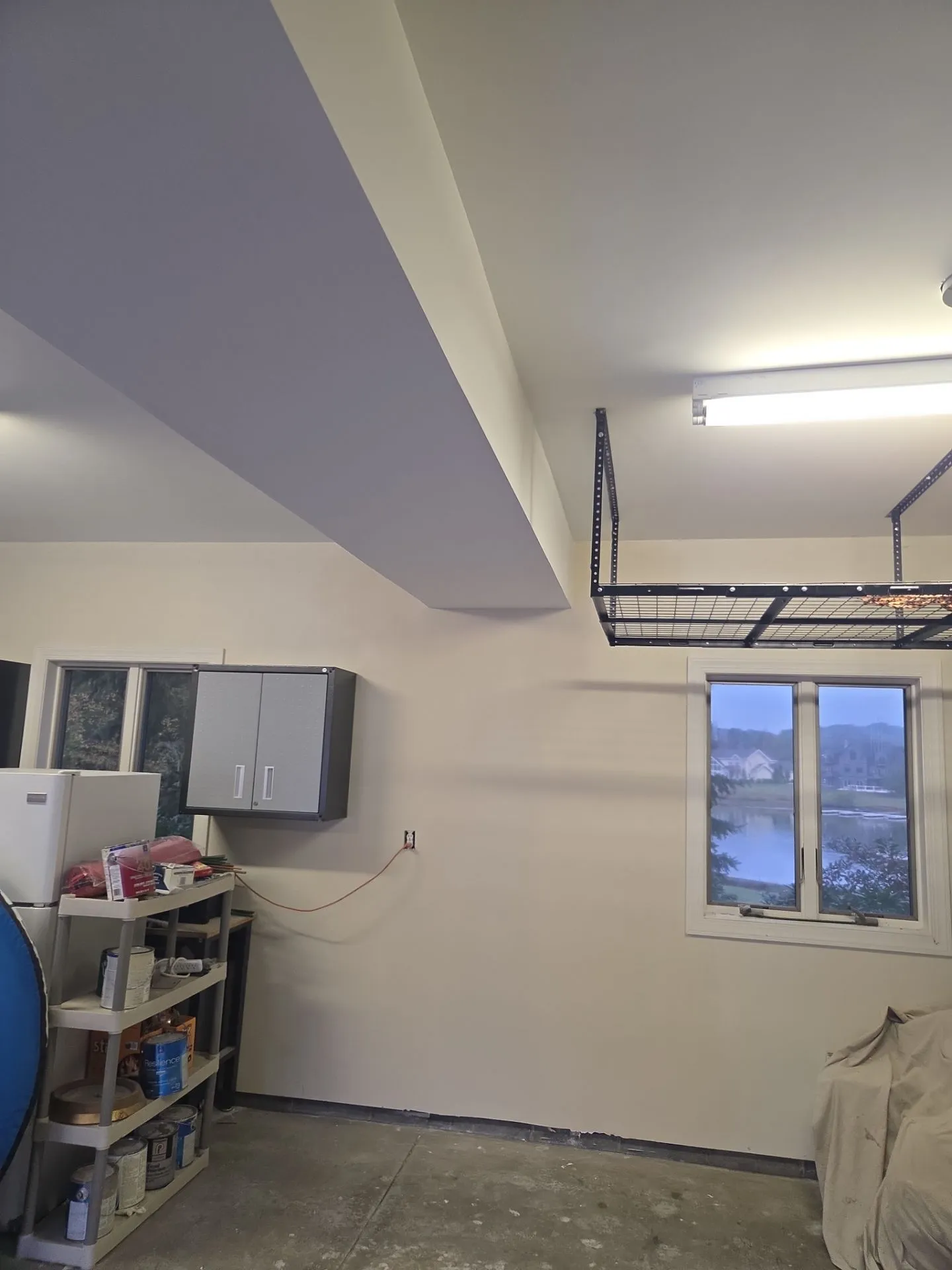 A garage ceiling repaired and refinished into a clean, bright space.