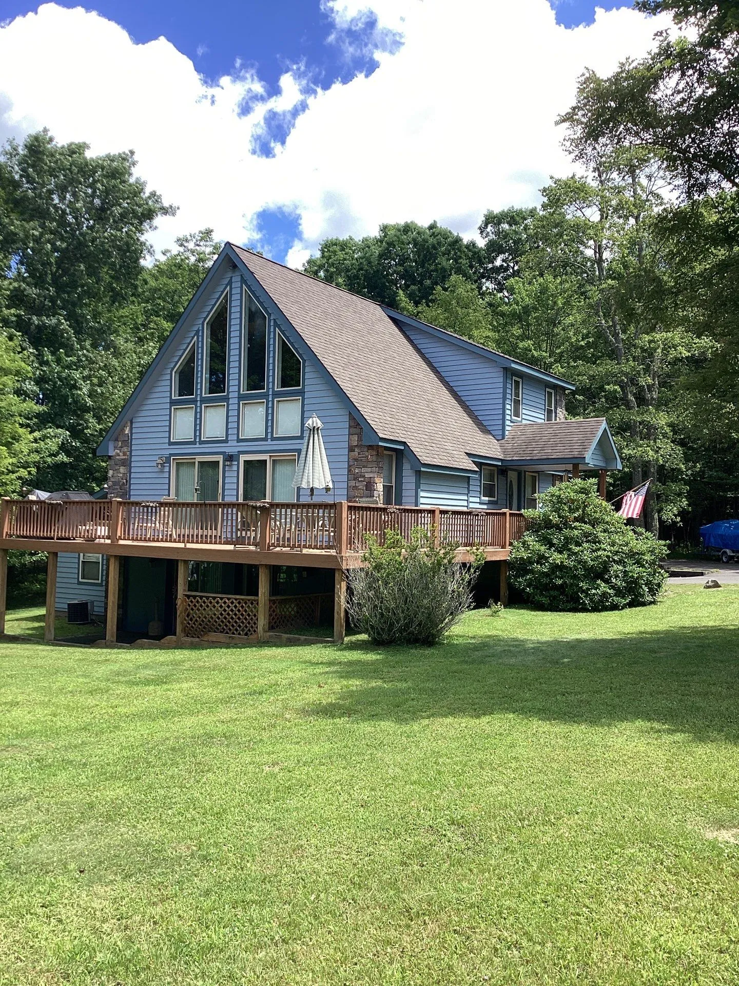 freshly painted and repaired blue lake house