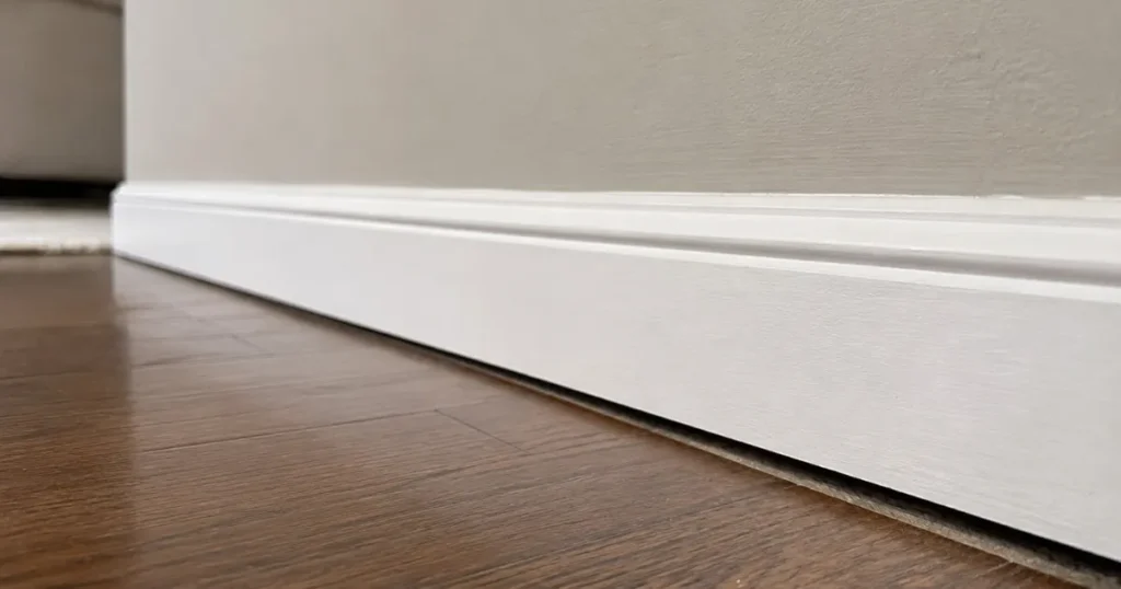 Small gap between a baseboard and hardwood floor from house settling