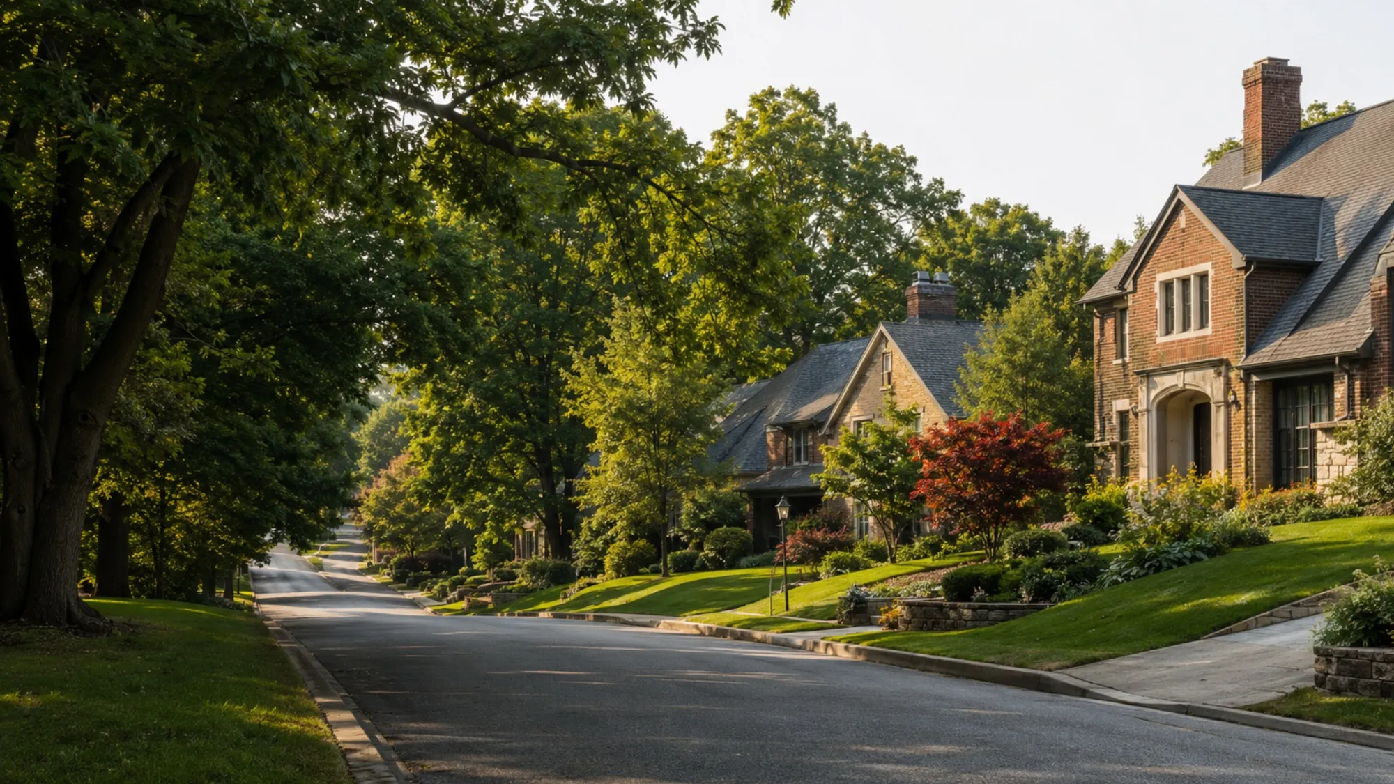 Tree-lined residential street with brick and stone homes in Upper St. Clair